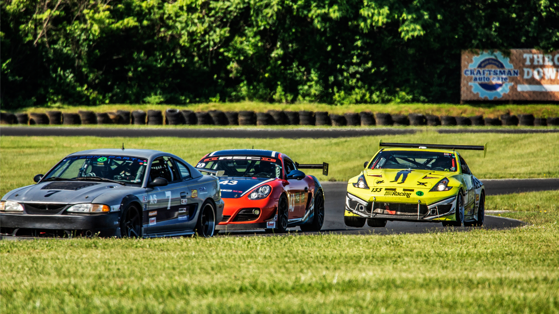 Busy Guys yellow racecar among other racecars